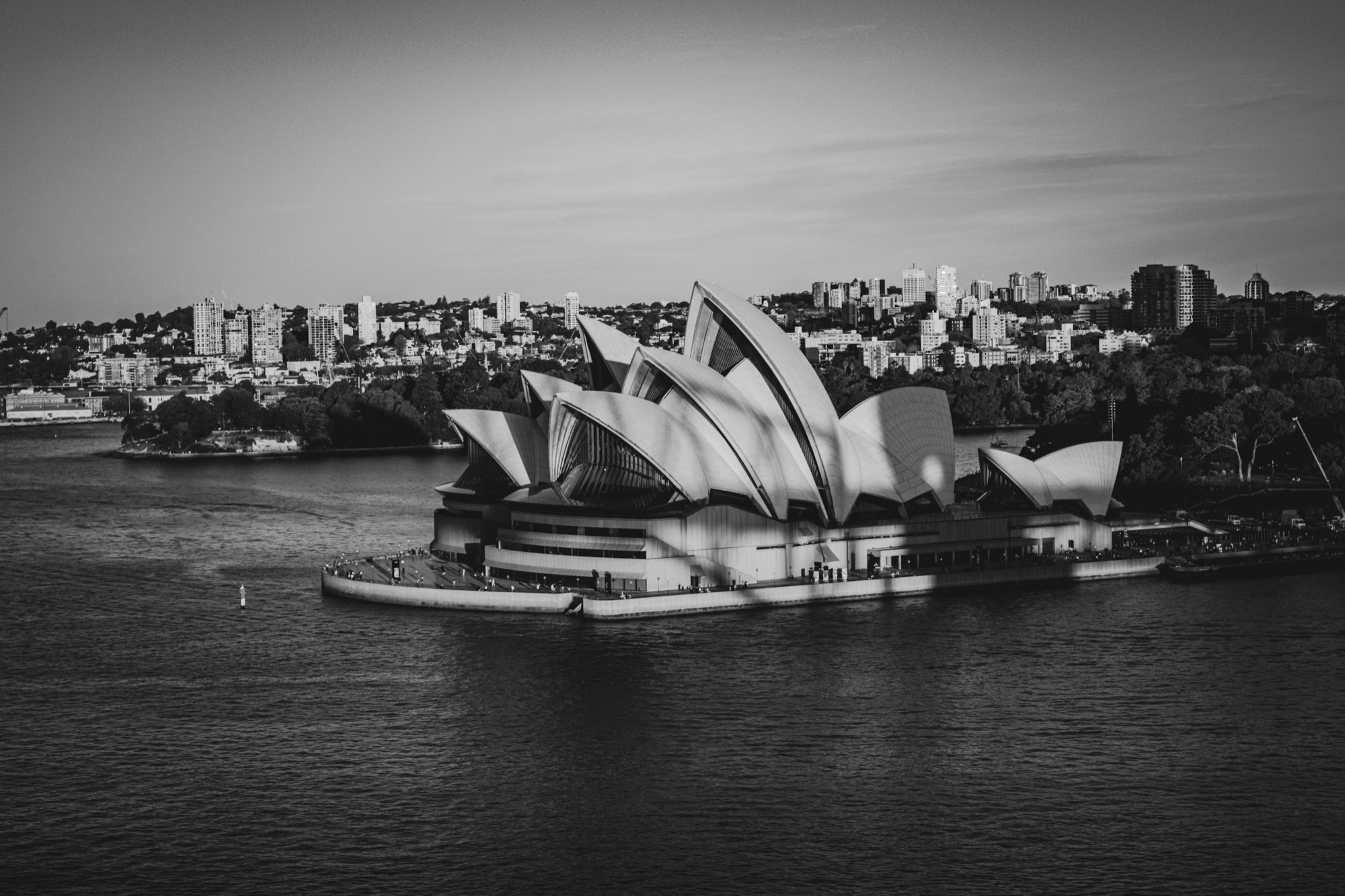 Sydney Opera House at dusk across the harbour